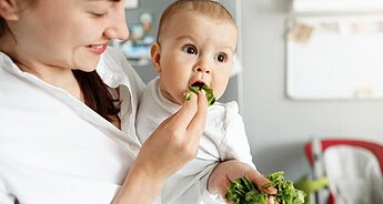 Baby eating greens