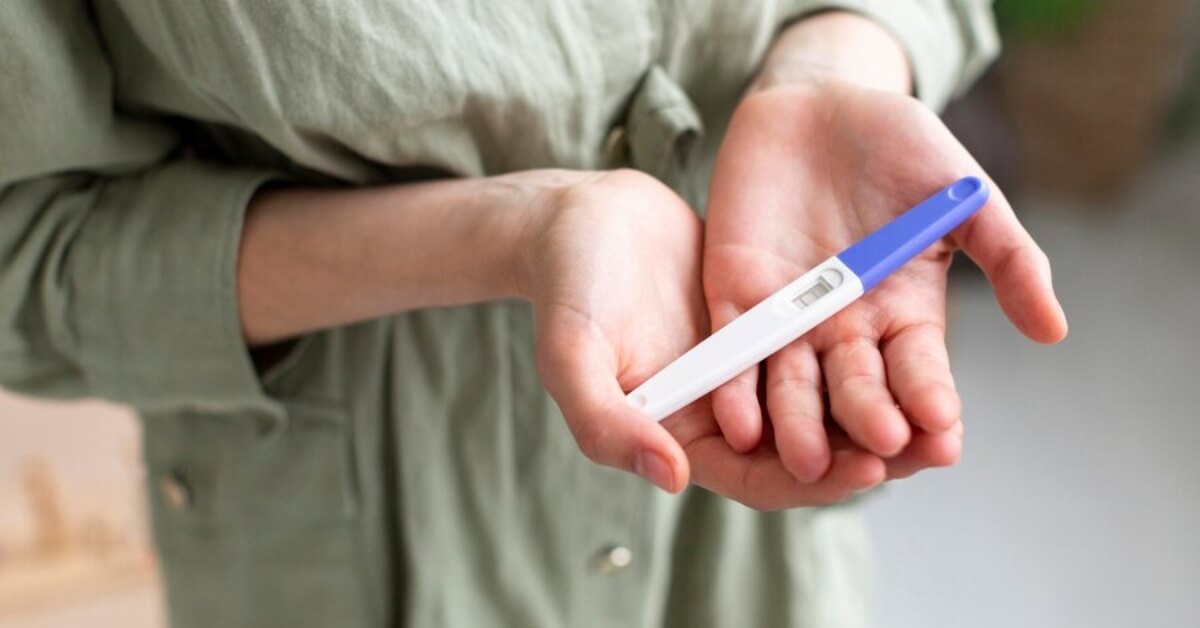 Expecting mum holding positive pregnancy test