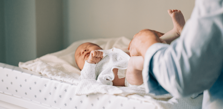 Newborn baby having it's nappy changed