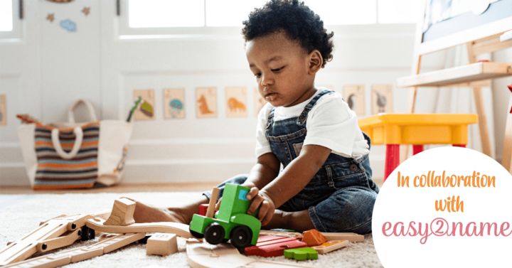 Little boy playing with wooden cars