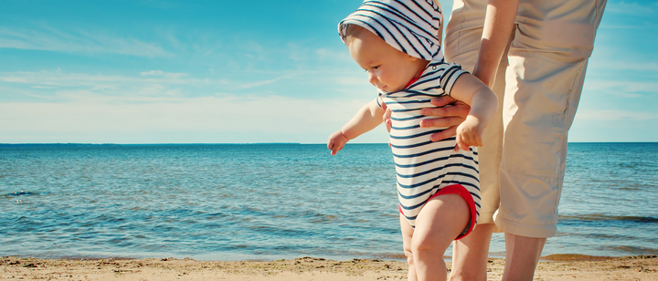 Baby walking on beach