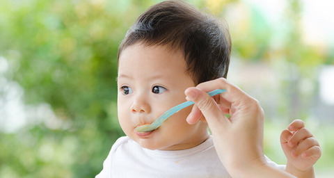 Baby being spoon fed