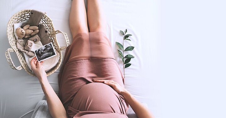 Pregnant woman preparing bassinet for baby's arrival