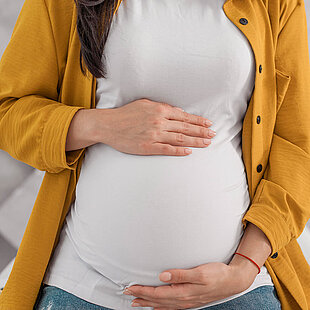 Woman cradling her bump