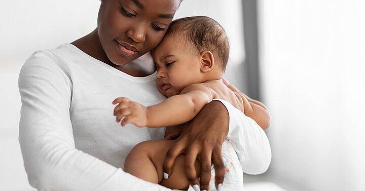 Mum cradling crying baby