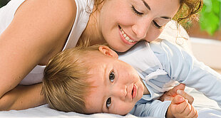 Woman cuddling a little boy