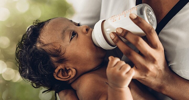 Mum bottle feeding baby