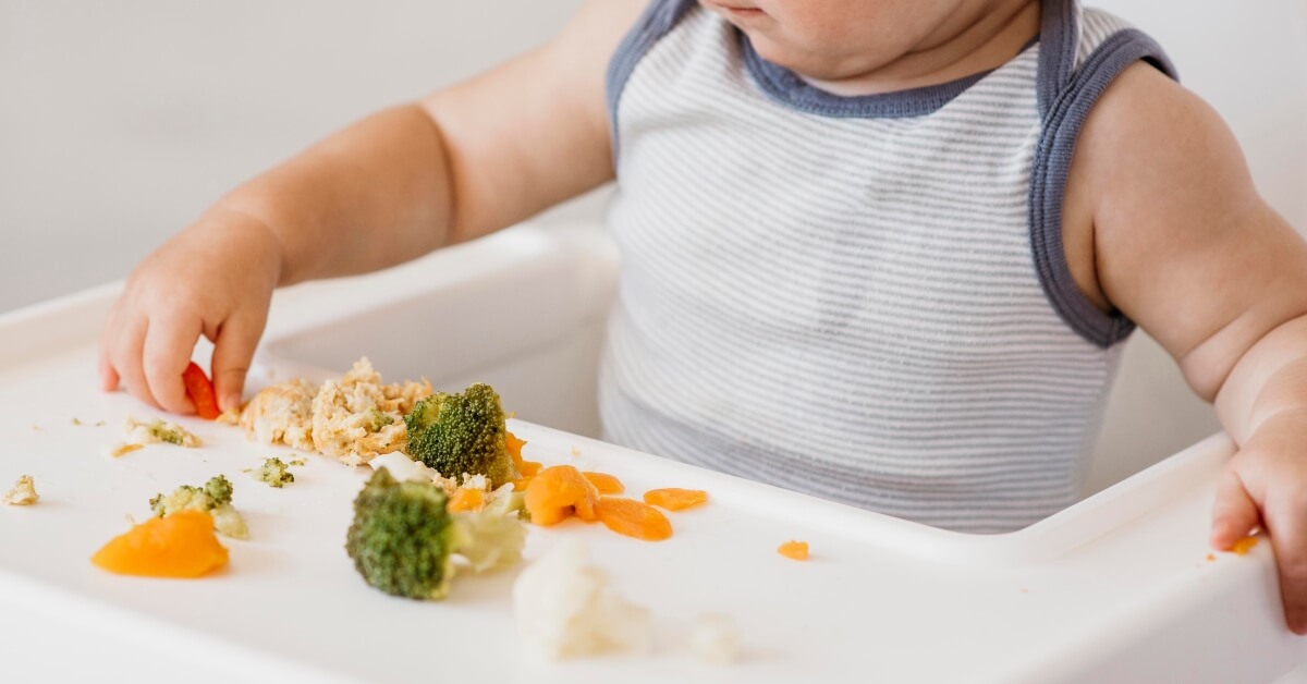 Baby eating vegetables