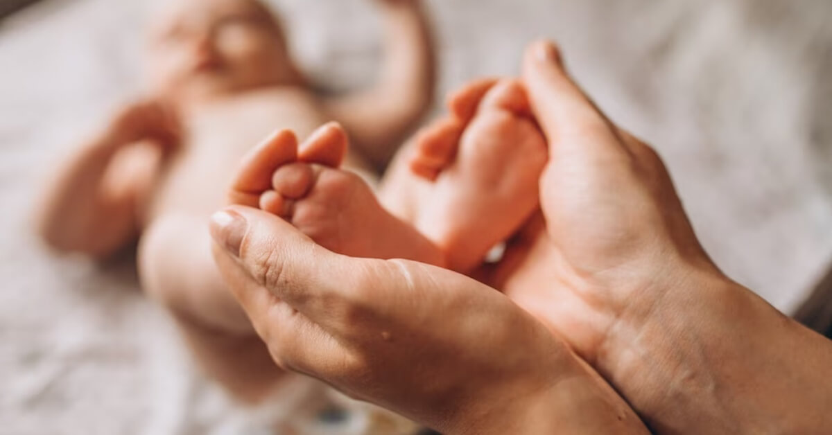 Mum holding baby's feet