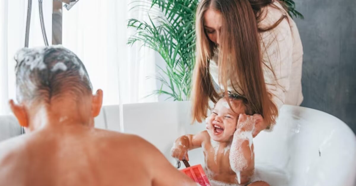 Mum washing baby in bath