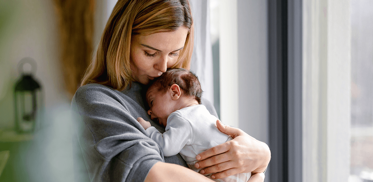 Mum soothing crying newborn