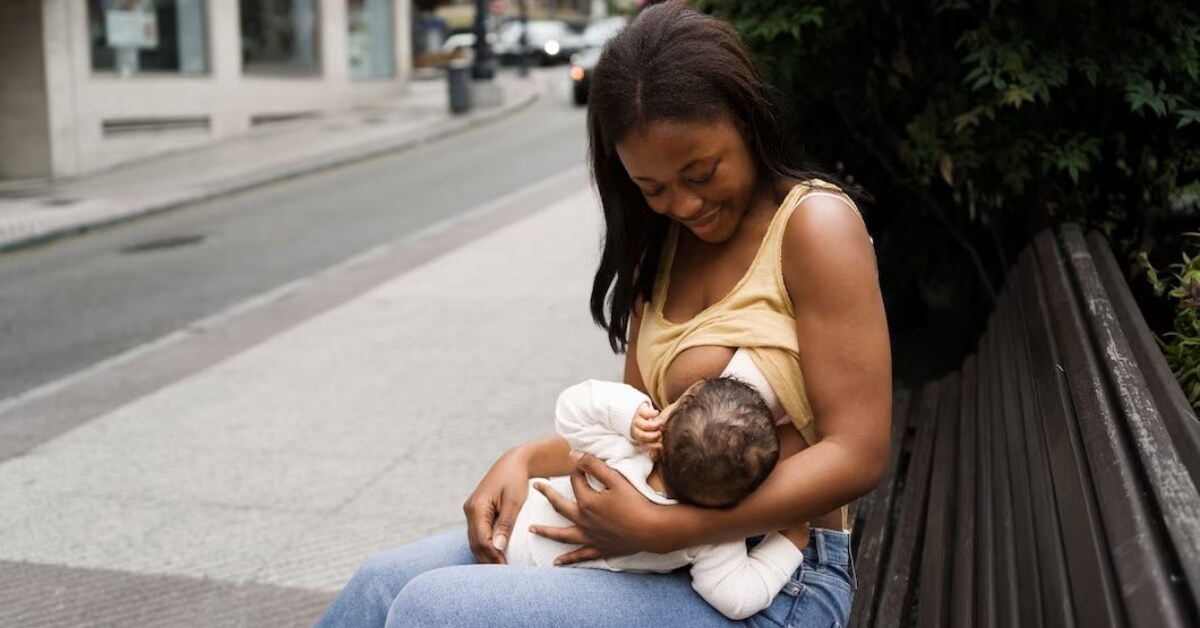 Mum breastfeeding baby on bench