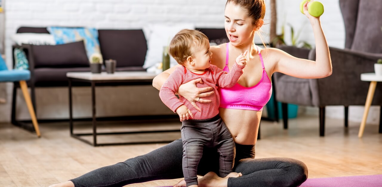 Mum working out with toddler on her lap