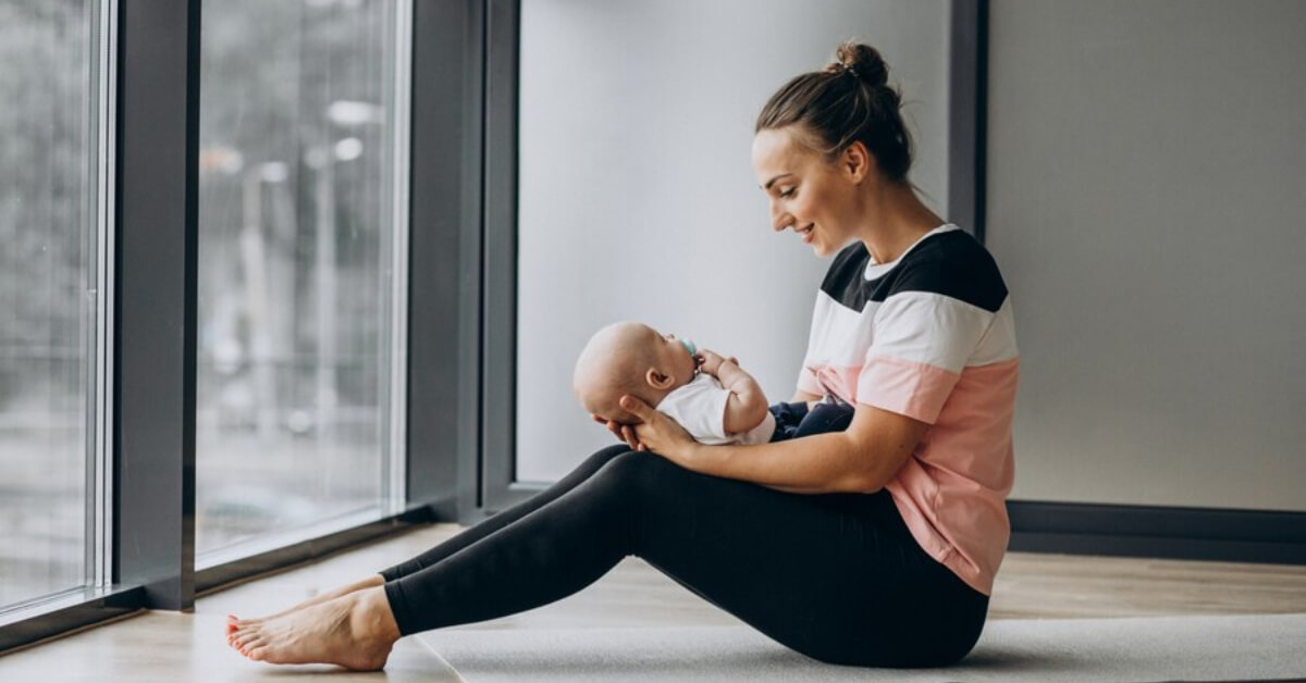 Yoga mum holding baby