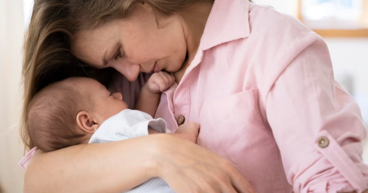 Mum cradling new born baby