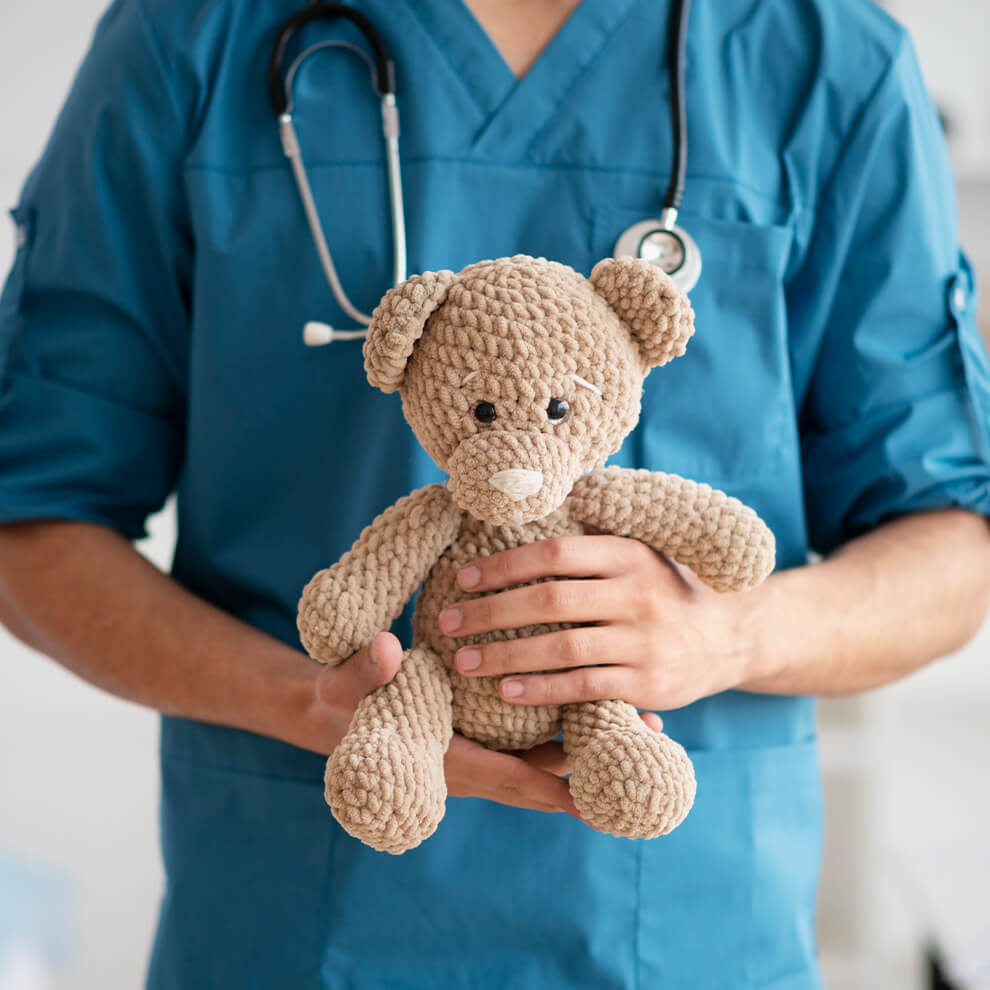 Doctor holding a teddy bear